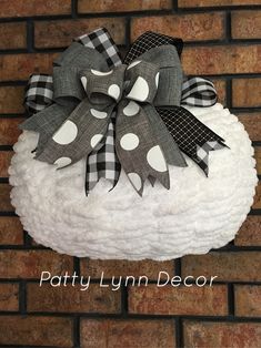 a black and white polka dot bow sitting on top of a sheep's head