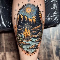 a man's leg with a campfire and mountains tattoo design on the thigh