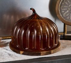 a chocolate cake sitting on top of a table next to a clock