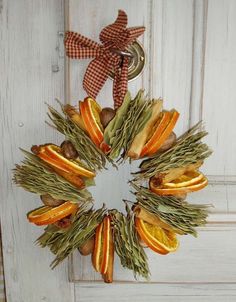 an orange and green wreath hanging on a door