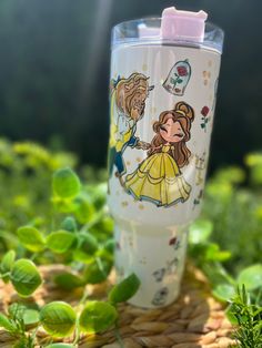 a plastic cup sitting on top of green grass