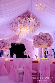 a wedding reception with pink and white decor