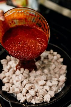 the sauce is being poured into the skillet with marshmallows in it