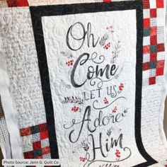 a quilt with the words oh come let us adore him