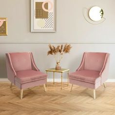 two pink chairs sitting next to each other on top of a hard wood floor