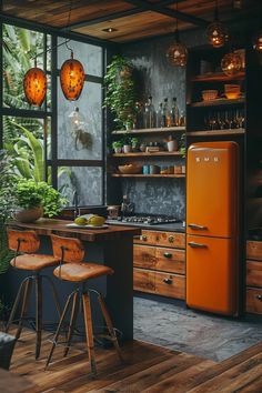 an orange refrigerator sitting in the middle of a kitchen next to wooden cabinets and stools