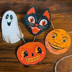 three paper pumpkins, one with a cat and the other with a ghost on it