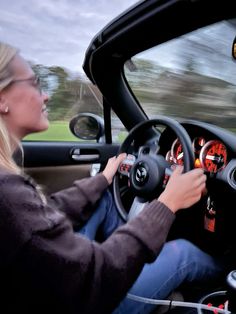 a woman driving a car on the road