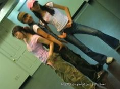 three young people posing for a photo in front of a mirror with their arms around each other