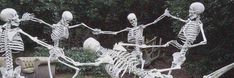 there are many skeletons in the yard with their arms and legs spread out as if they were dancing