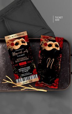 an image of a ticket for a masquerade party on a tray with gold and red decorations