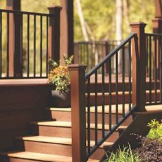 a wooden deck with railing and planters on it