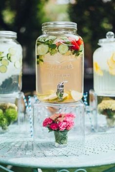 there are many different types of drinks in mason jars and vases on the table