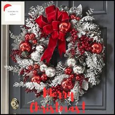 a christmas wreath with red and silver ornaments hanging on the front door to say merry christmas