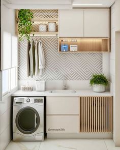 a washer and dryer in a small room with white tile flooring on the walls