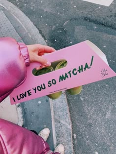 a person holding a pink sign that says i love you so match