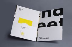 an open brochure with yellow and black letters on the front, inside it