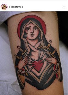 a woman with a heart and dagger tattoo on her leg