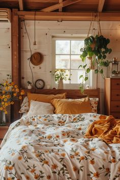 a bed in a bedroom with sunflowers on the comforter and yellow pillows