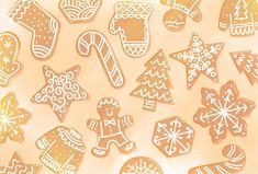 an assortment of gingerbread cutouts on a white and orange background with snowflakes, christmas trees, and candy canes