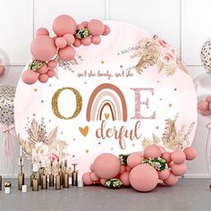 a pink and gold birthday backdrop with balloons, streamers, and confetti