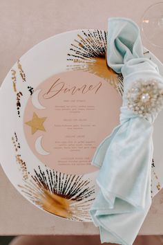 a white plate topped with a blue napkin and a star decoration on top of it