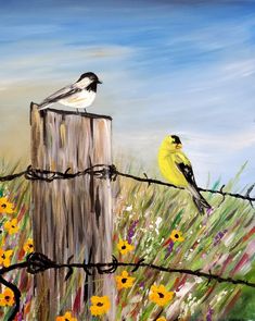 two birds sitting on top of a wooden fence post next to yellow and white flowers