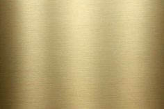 a gold metal background with some light reflections