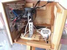 the inside of a wooden box with wires and other electrical equipment in it, labeled