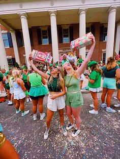 two girls are standing in front of a building with confetti all over them