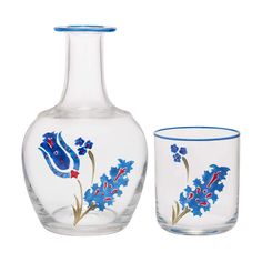 two vases and one glass with flowers painted on them