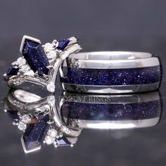 two wedding rings with blue and white diamonds