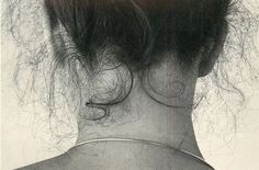 the back of a woman's head with hair in it and lines on her neck