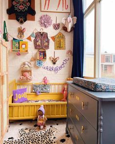 a child's room with toys and decor on the wall