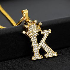 This Iced Out Crown Letter pendant is on a 24 inch gold plated 5mm Stainless Steel Miami Cuban Link Chain, Made with Hypo-allergenic and high-quality materials. Plated with genuine 24K gold. With the right care it will not fade or loose it's shine for a long time P A C K A G E ◾️ C O N T E NT 🎁Comes With Luxury Velvet Jewelry Gift Box Perfect For Gifting ♦️ Iced Out Crowned Letter Pendant ♦️ Gold Plated 5mm (24inch) Stainless Steel Miami Cuban Link Chain C A R E ∙ T I P S To maintain the qualit Initial Letter Necklace, Alphabet Pendant, Hip Hop Chains, Necklace Chain Types, Letter Jewelry, Crown Necklace, Letter Pendant Necklace, Nameplate Necklace, Unisex Necklace