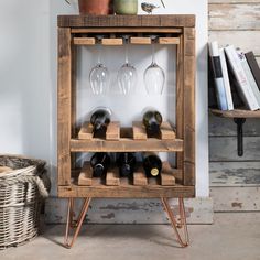 a wooden wine rack filled with bottles and glasses