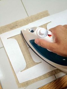 an image of someone using a sewing machine to sew fabric on the table top