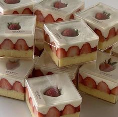 there are many slices of cake with strawberries on top