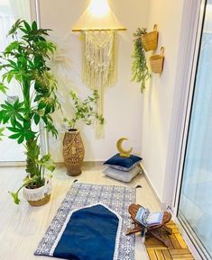 a room with plants and rugs on the floor