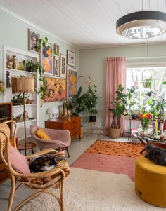 a living room filled with furniture and lots of plants