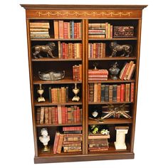 an antique bookcase with many books and figurines