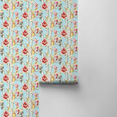 a blue wallpaper with red and white flowers on it