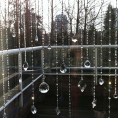 rain drops hanging from the side of a window