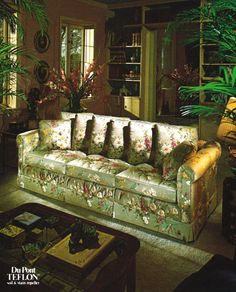 a living room filled with furniture and lots of plants