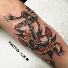 an anchor with flowers on it is shown in this tattoo design by matth houston