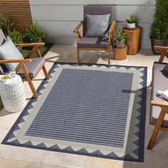 an outdoor area with chairs and rugs