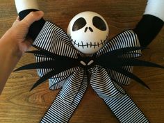 a person holding a fake skull with black and white stripes