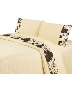 a bed with black and white cow print on it