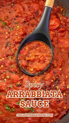 a pan filled with red sauce and a wooden spoon in the top right corner that says spicy arrabiaata sauce