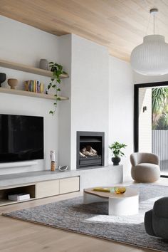 modern living room with fireplace and large screen tv